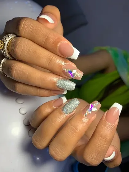 A classic French manicure on coffin-shaped nails, elevated with glitter and crystal accent nails. This is a popular choice for brides and bridesmaids.
