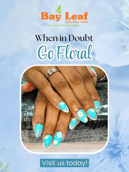 When in doubt, go floral. This bright and cheerful design features turquoise nails with daisy art and silver glitter accents for a fun, summery vibe.