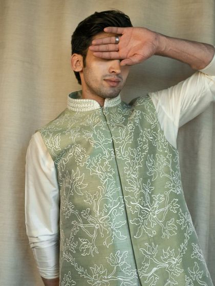 Shine in our stunning Pista Green Silk Jacket, beautifully adorned with intricate floral patterns. It's the perfect match for your Silk Kurta Pajama.