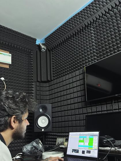 The producer working on the beat in his studio. I collaborate with top producers to make sure the music is as fire as the lyrics.