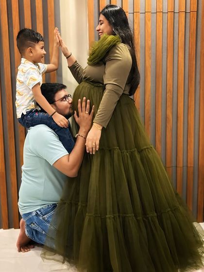 This olive green tiered gown is shown here in a family portrait, proving it's a wonderful choice for capturing moments with your loved ones.