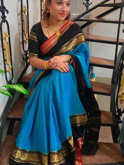 Another beautiful shot of the client on the stairs, showcasing the elegant drape of her saree.