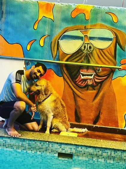 A happy pet parent with Bruno by the poolside. These are the moments we cherish, capturing the special bond between humans and their dogs.