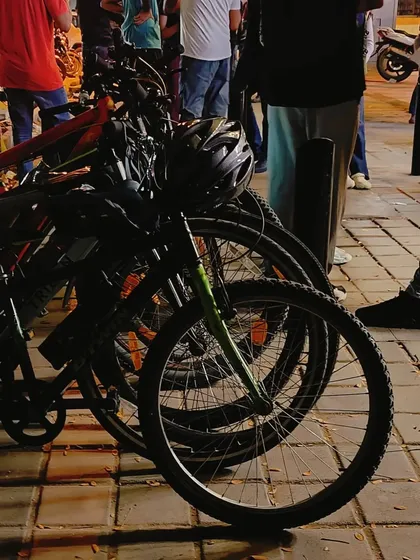 A close-up of our bikes parked together. The different wheels and frames represent the diverse individuals who make up our cycling family.