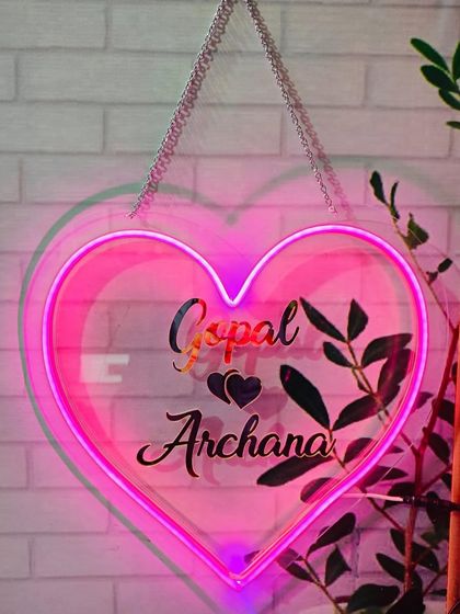 Another example of my custom neon heart prop. This one is in a vibrant pink, personalized with the couple's names, and ready to hang on the wall.