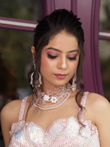 Two close-up shots of a model wearing our custom pink floral jewellery set. This is perfect for showcasing delicate, modern accessory styling.