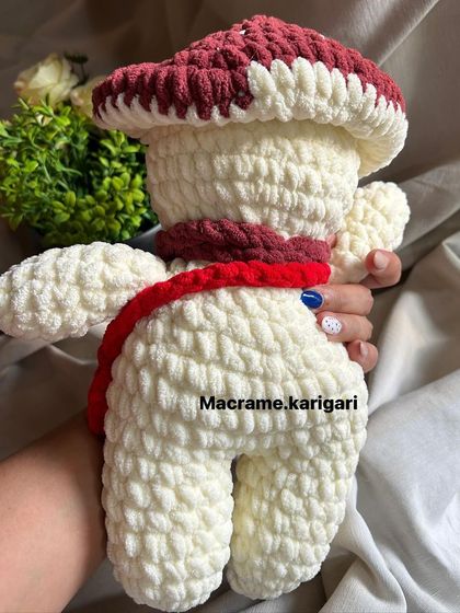 The back of the mushroom toy, highlighting its well-crafted shape and plush texture.