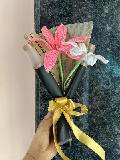 Holding the pink and white lily bouquet, a perfect blend of elegance and charm.
