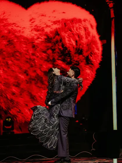 A Sangeet night is a performance of love. Here, I framed the couple against a giant, glowing heart on the LED screen, lifting them into a moment that is both epic and deeply romantic, capturing the peak of their celebration.