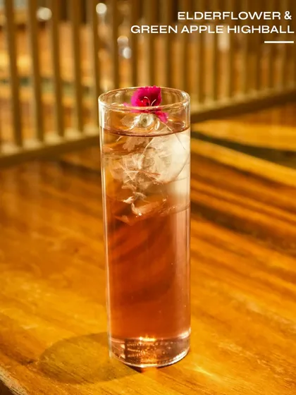 An Elderflower & Green Apple Highball, a light and floral drink. The combination of elderflower and crisp green apple makes for a perfectly refreshing sipper.