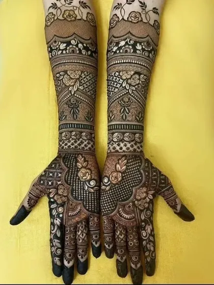 A beautiful floral mehendi design. This pattern uses roses and leaves to create a flowing, elegant look that covers the hands and arms.
