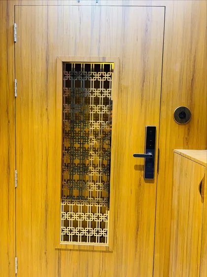 A detailed shot of the geometric jaali grill on the safety door.