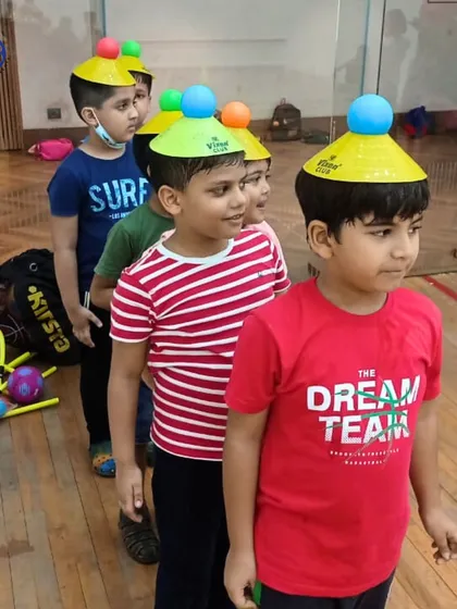 A fun balancing game where children line up with cones on their heads. This playful activity is a creative way to teach focus, posture, and balance.