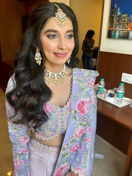 A happy, smiling portrait. The makeup is fresh and pretty, perfect for celebrating such a special occasion.