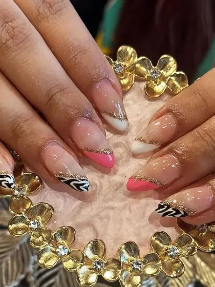 A wild and trendy mix-and-match set combining zebra print, pink, and white tips with a gold glitter line.