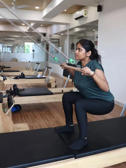 Using the Half Cadillac attachment on the reformer for squats and other exercises adds another layer of versatility to our workouts.