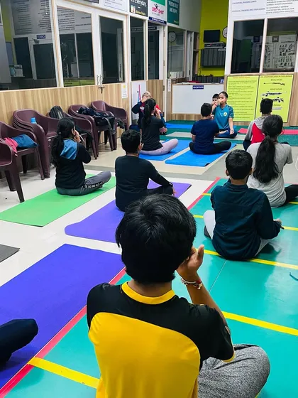 A group of our shooters learning breathing exercises (pranayama) during a yoga class. Controlled breathing is a vital skill for calming nerves during a competition.