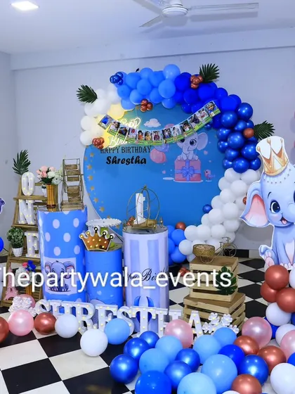 A wider shot of the baby elephant theme, showing how the decorations can fill a larger space with balloon columns and scattered balloons on the floor.