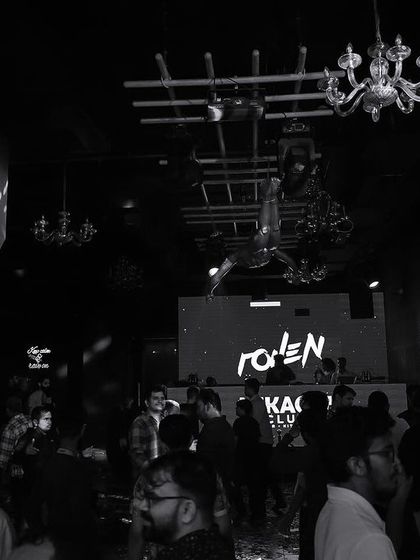 A wide black and white shot of the interior of Mikachi Club.