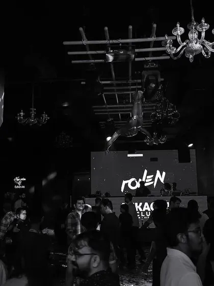 A wide black and white shot of the interior of Mikachi Club.