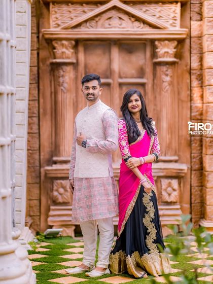 A classic portrait in front of a massive, carved wooden door, giving the photo a sense of grandeur and timelessness.