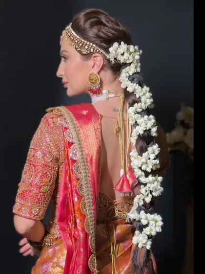 This side profile highlights how the braid complements the bride's jewelry and overall look. I teach you how to consider the entire ensemble when designing a hairstyle for a client.