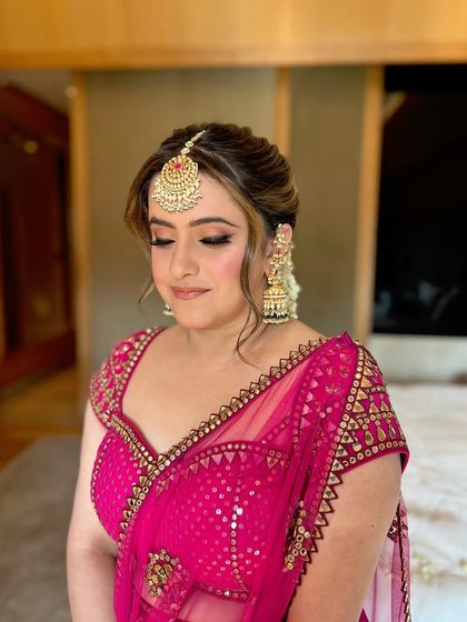 Eyes closed, highlighting the beautiful pink-toned eye makeup for the Mehendi.