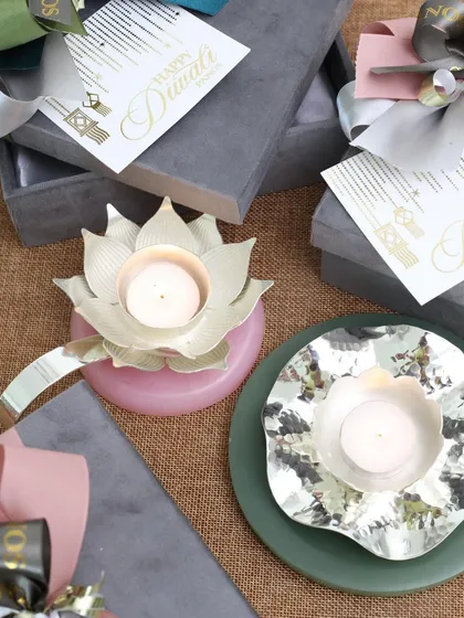 A duo of our modern silver-plated diyas, one with a lotus design and the other with an abstract flower shape. They are perfect for festive gifting or for elevating your own home temple.