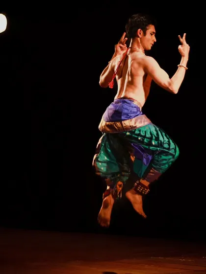 The athleticism of Kuchipudi in a single, frozen moment. This mid-air pose from the Samarpan festival showcases the demanding physical technique that underpins the expressive storytelling of the art form.