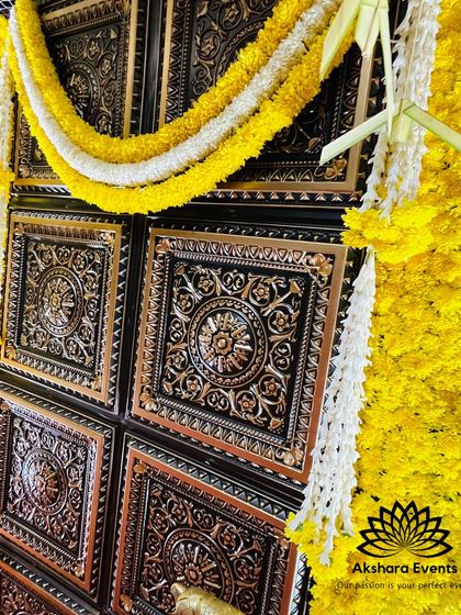 A close-up of the ornate, temple-style door panels used in some of my backdrops. The intricate carvings are highlighted by garlands of yellow and white flowers.