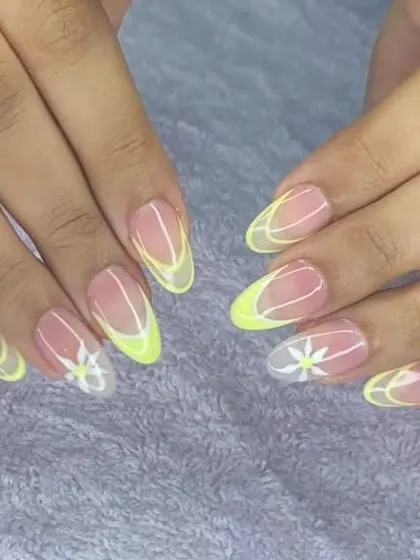 A fresh and simple design with a sheer base, neon yellow abstract tips, and a small white daisy accent.