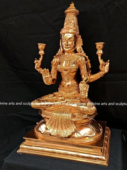 A stunning, gold-polished bronze statue of Lakshmi. The brilliant shine and intricate details make it a radiant centerpiece for any home altar.