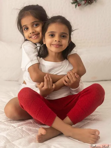 Two sisters sharing a sweet hug. Capturing the bond between siblings is one of my passions, creating a memory they can share forever.