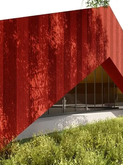 A concept image for the same project, showing a monolithic red structure emerging from a grassy slope. The triangular entrance portal creates a dramatic sense of arrival.