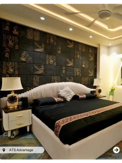 This bedroom makes a dramatic statement with a black accent wall featuring a traditional gold-embossed pattern. The design is a perfect fusion of modern luxury and classic Indian motifs.