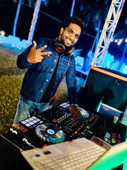 Ready to bring the party, day or night. A quick pose before the beat drops at an outdoor campus event.