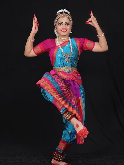 Niyati holding the classic Shiva pose, representing the lord holding the deer and axe. This pose requires great balance and strength.