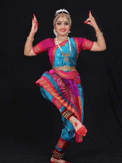 Niyati holding the classic Shiva pose, representing the lord holding the deer and axe. This pose requires great balance and strength.