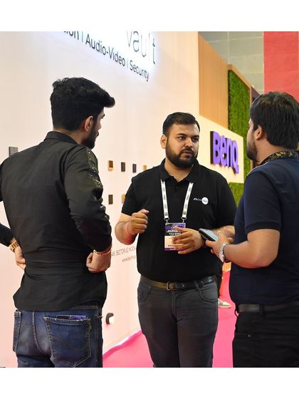 Our team is always ready to dive into the details. Here's a conversation happening at our product display wall.