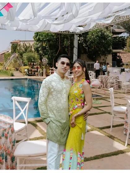The happy couple enjoying their poolside Mehendi, a perfect blend of relaxation and celebration.