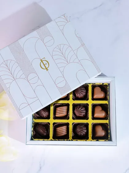 A classic gift for any occasion. This is my 12-piece praline collection, featuring an assortment of handmade milk and dark chocolates with various fillings. Each piece is crafted to be a delightful little indulgence, presented in an elegant, gift-ready box.