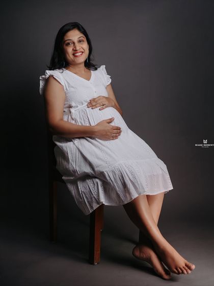 A relaxed and happy seated portrait. This pose is comfortable for the mom-to-be and results in a natural, beautiful photograph that radiates confidence.