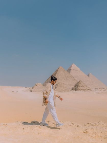 A shot of me walking in the desert, with the Giza pyramids in the distance. It captures the feeling of adventure and exploration that drives my travels.