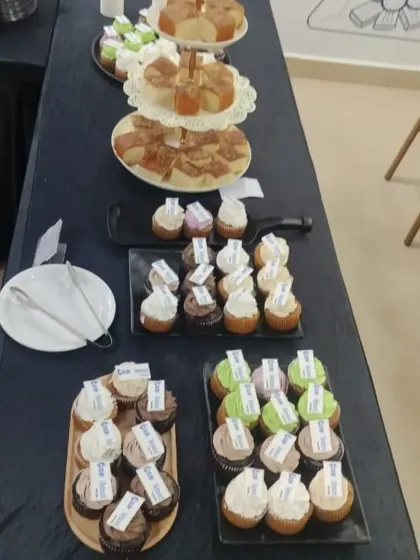 A variety of cupcakes and pastries elegantly arranged on tiered stands. We offer custom branding on our desserts, making them perfect for corporate events and product launches.