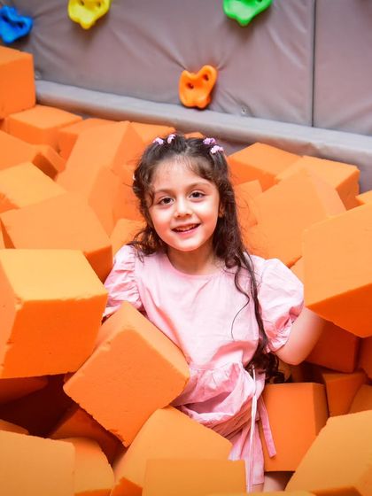 A happy smile from our foam pit. The pit is deep enough for fun jumps but shallow enough to be safe for younger children.
