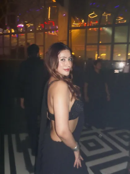 A back view of the black party saree, highlighting the stylish bralette and drape.