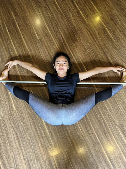 Using the ballet barre for an over-split. This type of assisted stretching helps our students safely increase their range of motion and achieve incredible flexibility.