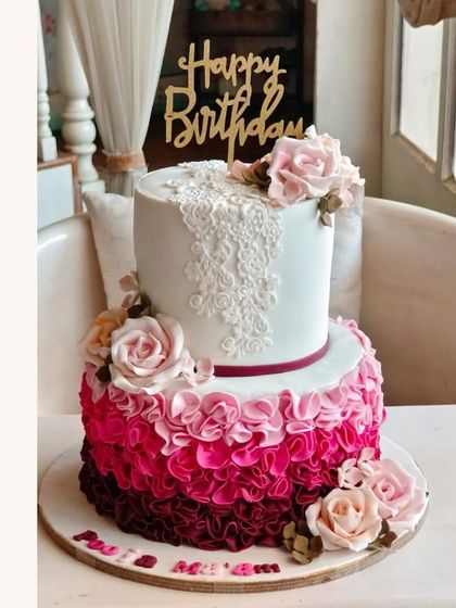 A beautiful two-tier cake with dramatic ombre ruffles, perfect for an elegant celebration.