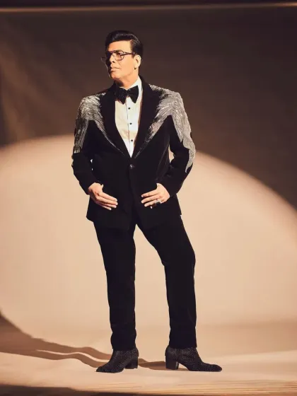 A studio shot of the black velvet tuxedo with silver beaded tassels, highlighting the expert craftsmanship.