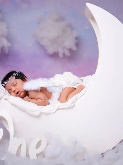 Sleeping on the moon, dreaming amongst the stars. This newborn angel photo captures the magic of their arrival.